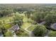 Aerial view of a vacant lot next to an existing home, located on a golf course at 7000 North Ridge Dr, Raleigh, NC 27615