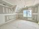 Unfinished attic space showing the potential for a bonus room with a window at 7000 North Ridge Dr, Raleigh, NC 27615
