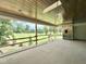 Covered back porch overlooking a beautiful yard and lake, perfect for relaxation at 7000 North Ridge Dr, Raleigh, NC 27615