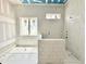 Bathroom with tile surround, highlighting the modern design and window for natural light at 7000 North Ridge Dr, Raleigh, NC 27615