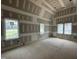 Bedroom with multiple windows showing the drywall, trimwork, and ceiling work in progress at 7000 North Ridge Dr, Raleigh, NC 27615