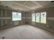 Bright bedroom featuring large windows providing abundant natural light and views of a tree filled yard at 7000 North Ridge Dr, Raleigh, NC 27615