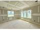 Unfinished bedroom with many windows, great natural light, and relaxing view of yard at 7000 North Ridge Dr, Raleigh, NC 27615