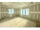 Spacious bedroom featuring drywall and large windows for natural light; in progress at 7000 North Ridge Dr, Raleigh, NC 27615