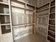 Spacious walk-in closet featuring custom shelving and ample storage solutions at 7000 North Ridge Dr, Raleigh, NC 27615