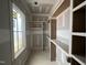 Custom walk-in closet with shelving and hanging racks being built at 7000 North Ridge Dr, Raleigh, NC 27615