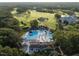 Aerial view of a sparkling community pool area with lounging chairs and lush trees at 7000 North Ridge Dr, Raleigh, NC 27615