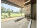 Covered patio with a built-in fireplace and an open view of the lush green golf course at 7000 North Ridge Dr, Raleigh, NC 27615