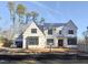 New construction home featuring black-framed windows and Homestead Guard house wrap at 7000 North Ridge Dr, Raleigh, NC 27615