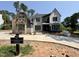 Two-story home with mixed exteriors of stone, stucco, and siding, and black window frames, under construction by Homestead Building Company at 7000 North Ridge Dr, Raleigh, NC 27615