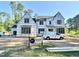 View of new construction home with modern farmhouse design, featuring large windows and covered porch at 7000 North Ridge Dr, Raleigh, NC 27615