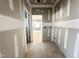 Hallway with drywall ready for paint, and doorway leading to a bright room at 7000 North Ridge Dr, Raleigh, NC 27615