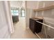 View into a new home's hallway featuring custom cabinetry and a glimpse of the large sliding doors at 7000 North Ridge Dr, Raleigh, NC 27615