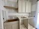 Laundry room with utility sink and cabinets, designed for efficient organization and convenience at 7000 North Ridge Dr, Raleigh, NC 27615