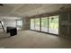 Open concept living room featuring large sliding glass doors at 7000 North Ridge Dr, Raleigh, NC 27615