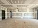 Spacious living room featuring unfinished drywall, with archway to another room at 7000 North Ridge Dr, Raleigh, NC 27615