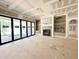 Bright living room with large sliding doors and built-in shelves flanking a modern fireplace at 7000 North Ridge Dr, Raleigh, NC 27615