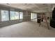 Bright, open-concept living room features large windows with backyard views at 7000 North Ridge Dr, Raleigh, NC 27615
