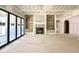 Spacious living room featuring a fireplace, built-in shelves and large sliding doors for natural light at 7000 North Ridge Dr, Raleigh, NC 27615