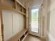 Bright mudroom features a built-in bench with storage and a door to the outside at 7000 North Ridge Dr, Raleigh, NC 27615