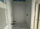 Contemporary shower with white tiled walls, niche, and modern fixtures at 7000 North Ridge Dr, Raleigh, NC 27615