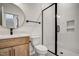 A modern bathroom with a glass shower and a stylish round mirror at 90 Lambert Ln, Fuquay Varina, NC 27526