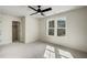 Spacious bedroom featuring neutral carpet, natural light from double windows, and a ceiling fan at 90 Lambert Ln, Fuquay Varina, NC 27526