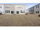 Backyard with newly planted grass and an external view of townhomes at 28 Nettle Ln # 235, Clayton, NC 27520