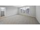 Bright bedroom with a neutral color scheme, carpet floors, and bright windows with coverings for optimal privacy at 28 Nettle Ln # 235, Clayton, NC 27520