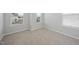 Bedroom with neutral paint, carpet, and windows allowing for natural light at 28 Nettle Ln # 235, Clayton, NC 27520