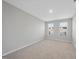 Bedroom with neutral paint, carpet, and windows allowing for natural light at 28 Nettle Ln # 235, Clayton, NC 27520