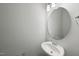 Half bath featuring a round mirror and chrome faucet at 28 Nettle Ln # 235, Clayton, NC 27520