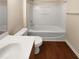 Clean bathroom featuring a shower-tub combo, modern fixtures, and stylish wood-look flooring at 330 Gilman Ln # 106, Raleigh, NC 27610