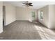 Large bedroom with plush carpeting, a ceiling fan, and multiple windows providing plenty of natural light at 330 Gilman Ln # 106, Raleigh, NC 27610
