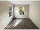 Bright bedroom featuring carpet, neutral walls and two windows overlooking the yard at 330 Gilman Ln # 106, Raleigh, NC 27610
