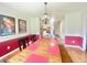 Formal dining room featuring a long wooden table, chandelier, and decorative wall art for elegant gatherings at 4200 Harmony Church, Efland, NC 27243