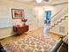 Inviting living room with hardwood floors, area rug, and staircase enhancing the home's charm at 4200 Harmony Church, Efland, NC 27243