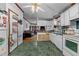 Kitchen with white cabinets and green flooring at 118 W Silver Belle Dr, Zebulon, NC 27597
