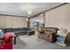 Spacious living room with L-shaped sofa and view into the kitchen at 118 W Silver Belle Dr, Zebulon, NC 27597