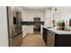 Modern kitchen featuring marble countertops, stainless steel appliances, and custom tile backsplash at 4031 Elk Creek Ln # 20, Raleigh, NC 27612