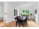 Bright dining room with hardwood floors, modern decor, and a large window at 1511 Malta Ave, Raleigh, NC 27610