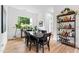 Bright dining room featuring a dark wood table set and a window view of lush greenery at 1511 Malta Ave, Raleigh, NC 27610