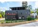 Modern three-story home with a black exterior, rooftop patio, and professionally landscaped front yard at 1511 Malta Ave, Raleigh, NC 27610
