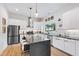 Modern kitchen featuring stainless steel appliances, a large island, and sleek white cabinetry at 1511 Malta Ave, Raleigh, NC 27610