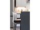 Close-up of a kitchen island with modern bar stools and sleek countertops at 1511 Malta Ave, Raleigh, NC 27610