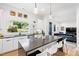 Bright, modern kitchen featuring a large island, white cabinets, stainless steel appliances, and an open layout at 1511 Malta Ave, Raleigh, NC 27610
