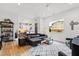 Bright living room featuring hardwood floors, modern furnishings, and abundant natural light at 1511 Malta Ave, Raleigh, NC 27610