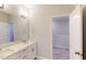 The bathroom has a double vanity, large mirror, modern lighting, and an open doorway to another room at 3181 Mission Olive Pl # 346, New Hill, NC 27562