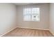 An empty bedroom is shown with a window and plush carpet at 3181 Mission Olive Pl # 346, New Hill, NC 27562
