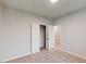 A bright, empty bedroom showcases a closet with bifold doors and easy access to an adjoining room at 3181 Mission Olive Pl # 346, New Hill, NC 27562